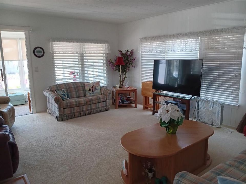 NICE OPEN  LIVING SPACE THAT LEADS TO THE ENCLOSED LANAI