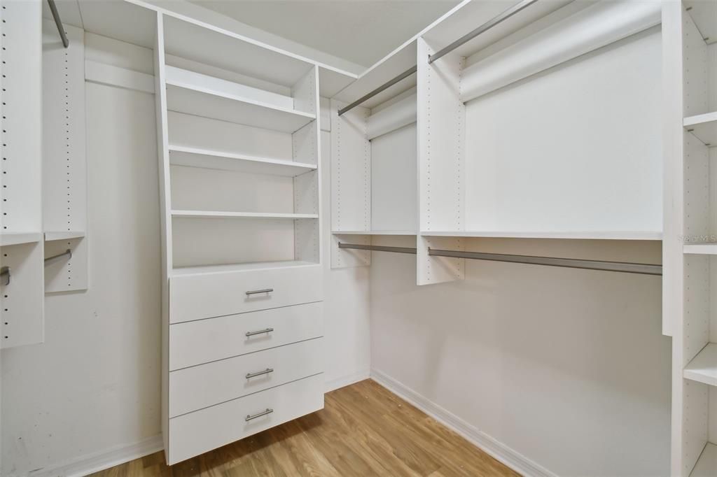 Large Primary bedroom closet with built in closet organization