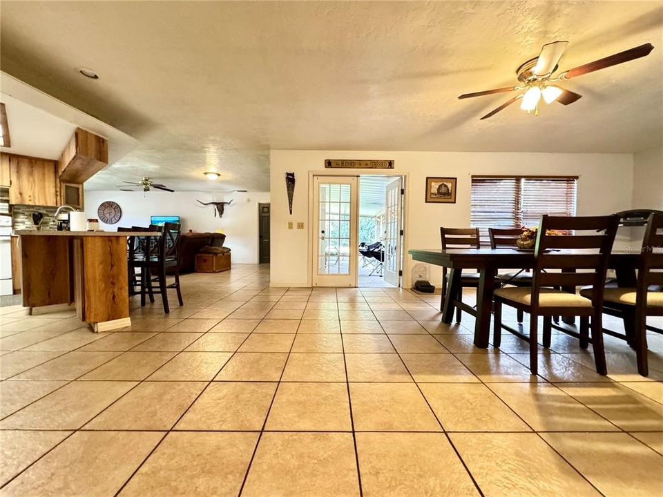 View of open area between kitchen and dining with french doors to patio