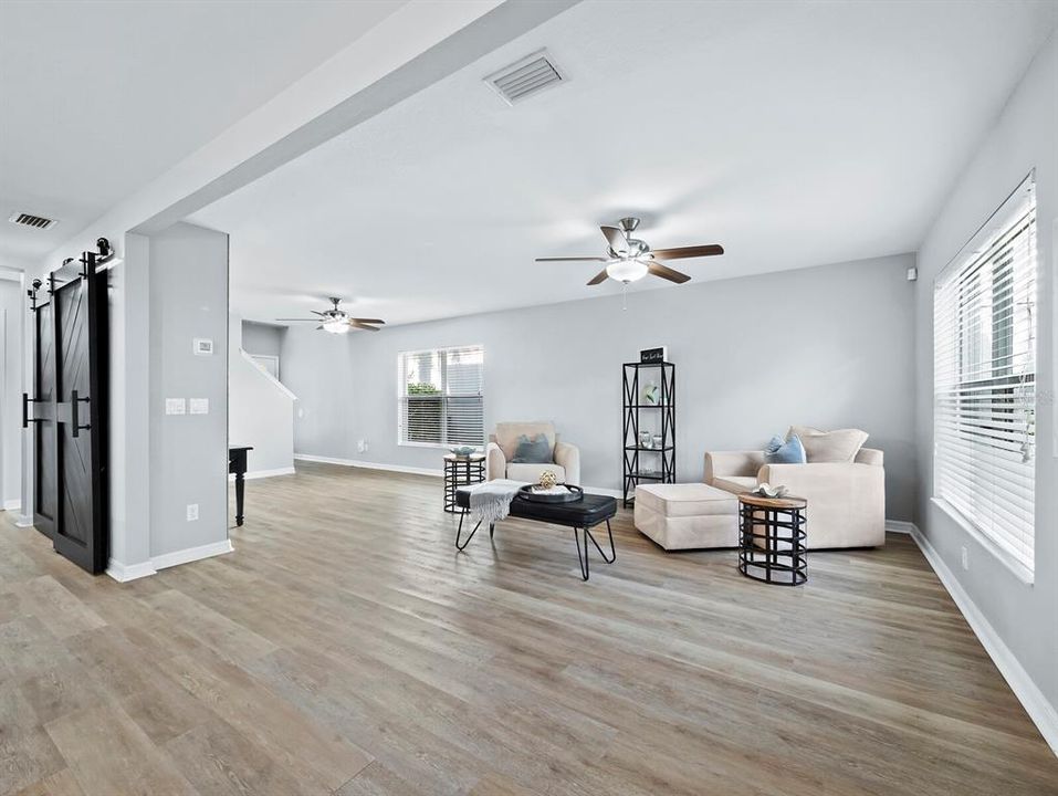 Open to the dining area and kitchen, freshly painted and filled with light