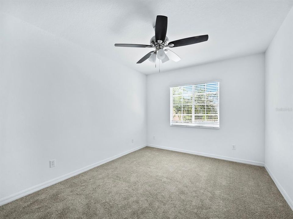 Bedroom 2 with brand new carpet and a walk-in closet