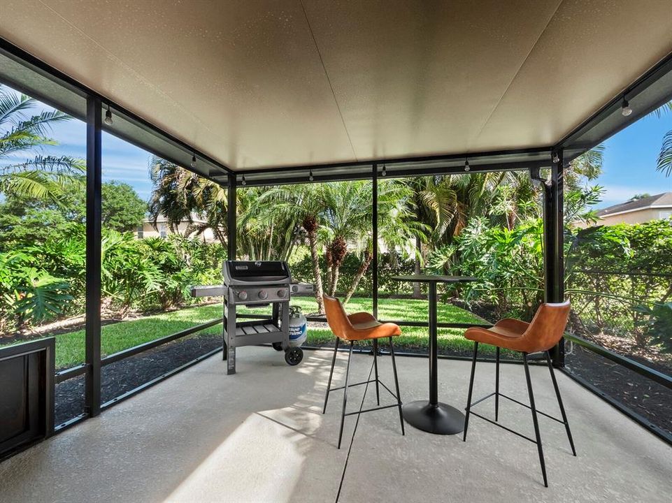 The screened in lanai is perfect for grilling and enjoying indoor/outdoor living and the beautiful fenced in backyard