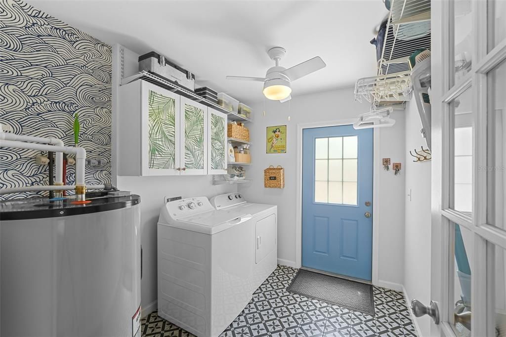 Laundry room with additional storage and shelving