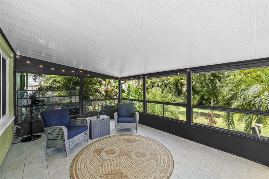 LARGE covered screened sunroom, view of yard