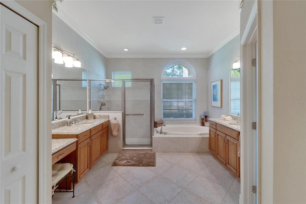 This Ensuite features, comfort height sinks, with granite counters, seperate soaking tub, and oversized glass enclosed shower.  Don't miss the Travertine floors with decorative inlays.