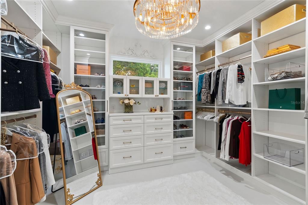 One of the primary closets- custom California Closets cabinetry and gorgeous chandelier