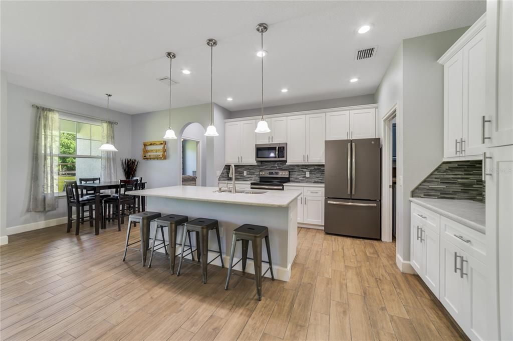 Your kitchen is a home chef’s dream featuring chic SHAKER STYLE CABINETRY, casual dining in the breakfast nook and at the bar on the ISLAND, decorative backsplash, STAINLESS STEEL APPLIANCES and the cherry on top are the QUARTZ COUNTERS!