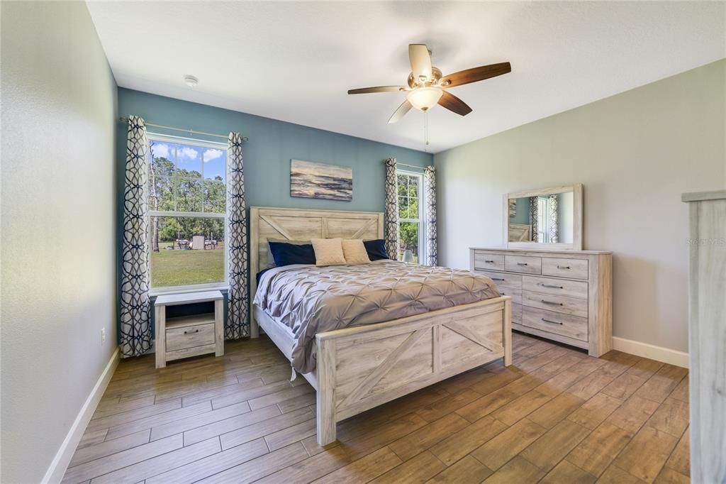 Ideal SPLIT BEDROOMS let you escape into a tranquil PRIMARY SUITE where the coastal vibe continues, there are twin windows for more great light, large WALK-IN CLOSET and a private bath.