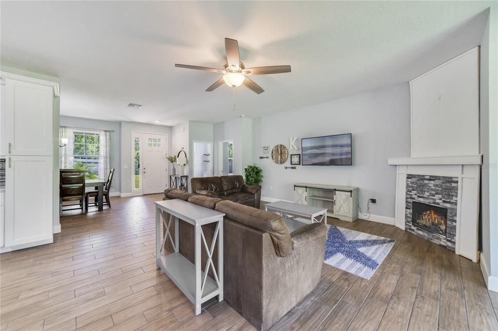 High ceilings add the open feel and there are WOOD LOOK TILE FLOORS throughout complimenting the thoughtful accents in the kitchen, baths and around the FIREPLACE in the living room.