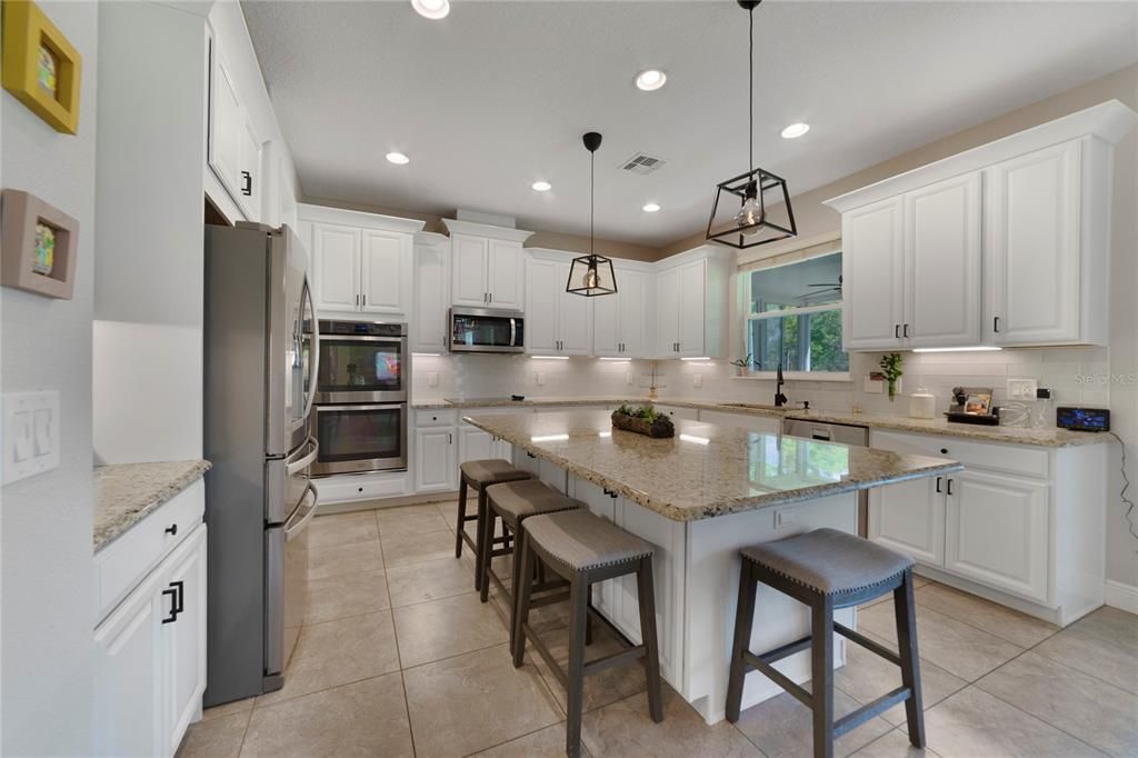 The home chef will fall in love at first sight with the well appointed kitchen offering STAINLESS STEEL APPLIANCES, large WALK-IN PANTRY, GRANITE COUNTERS and an oversized ISLAND in the center of it all.