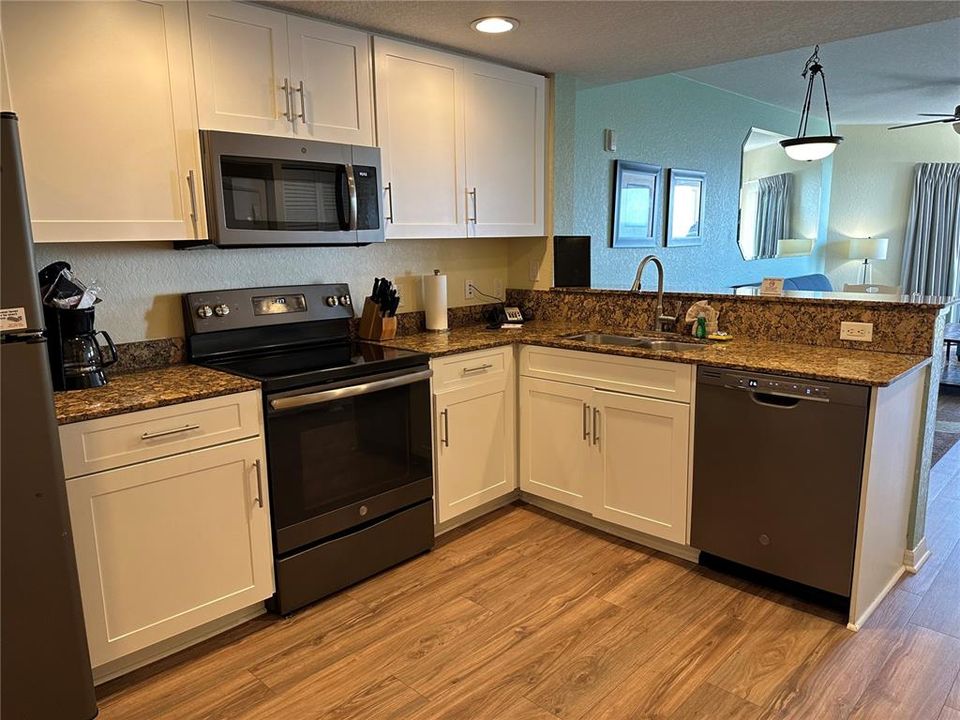Full kitchen with stainless steel appliances and granite countertops