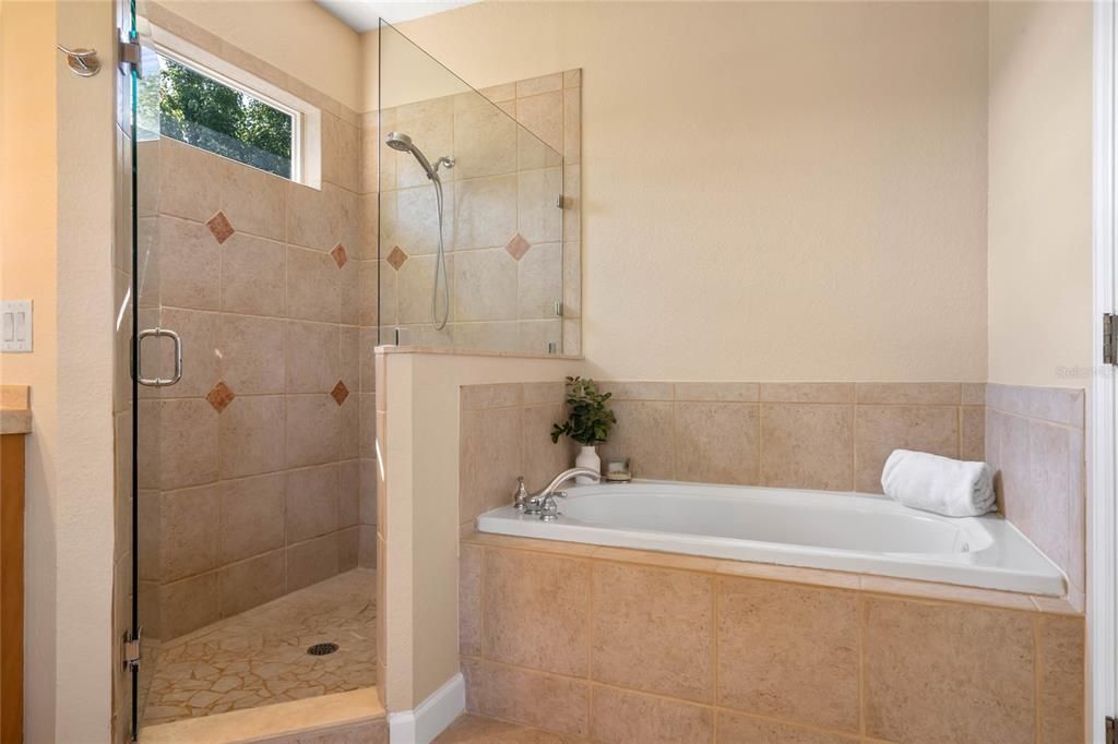 Primary ensuite with jacuzzi soaking tub and large shower