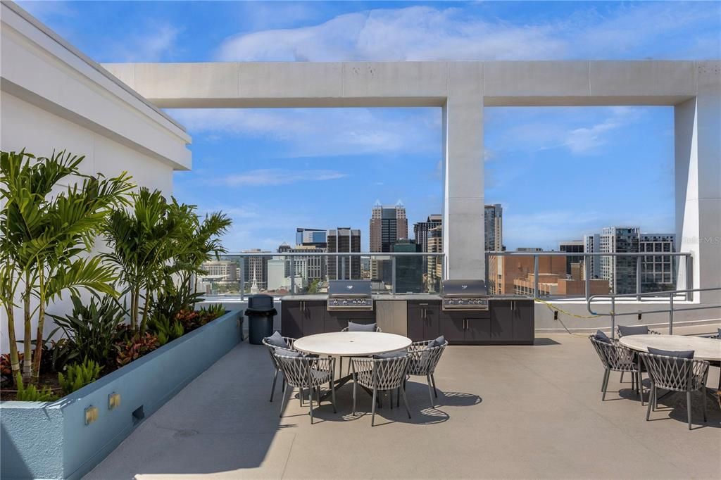 North side Rooftop, 2023 completed, this out door kitchen includes, 2 grills, a fridge, ice cooler for drinks built in (right end).  Dining tables/chairs, New palms and plants. The view at night over the city is a must see at Star Tower.
