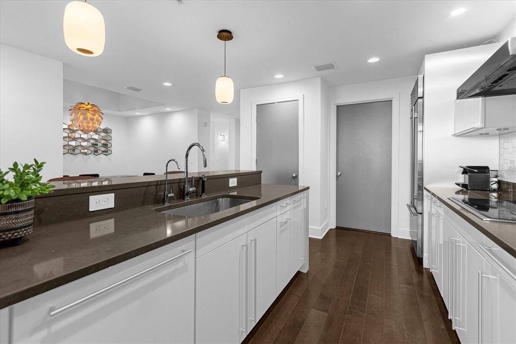 Classic and elegant, neutrals with earthly accents from wood flooring and countertops. NOTE: grey accent tone on all interior doors. NOTE: ceiling cans on dimmer. Also NOTE: drinking water purification (left of faucet).
