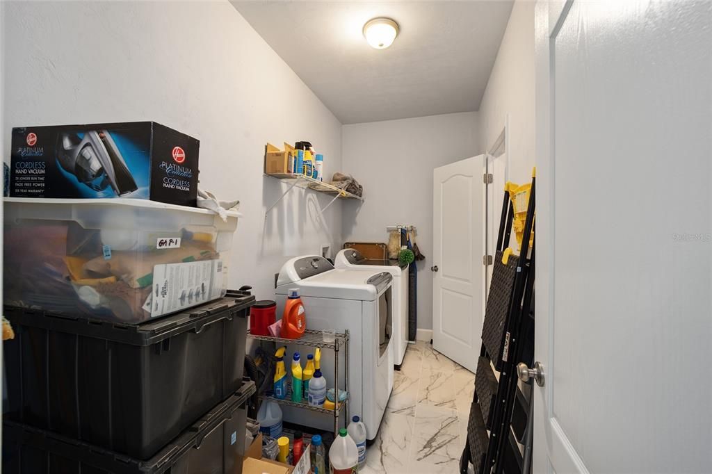 Laundry room that leads right off of the master closet