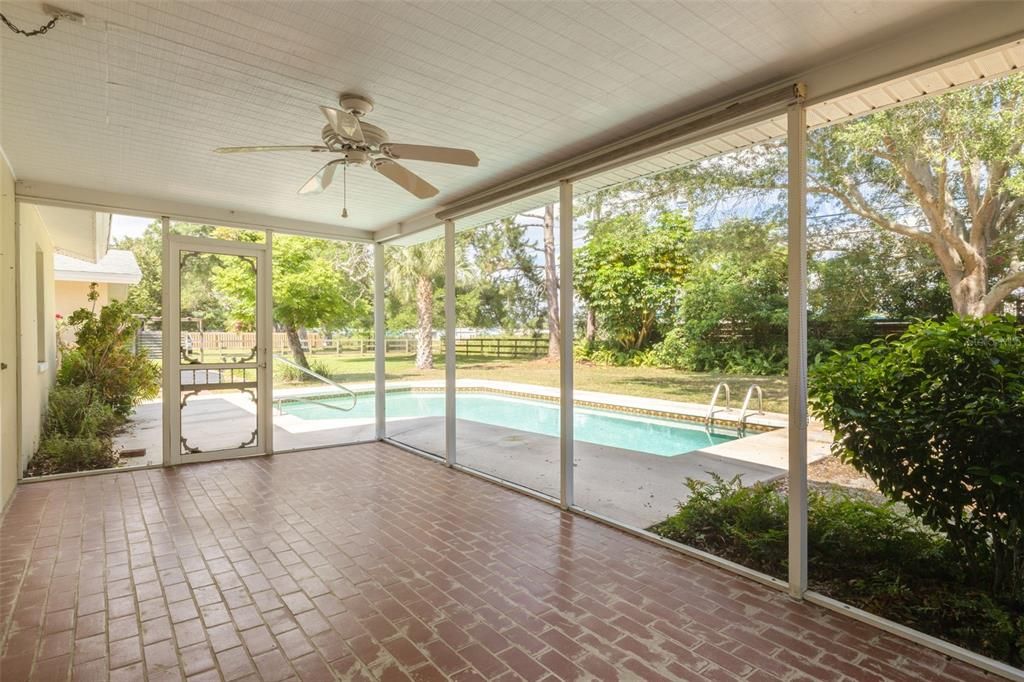 Screened porch overlooking the pool and large lot