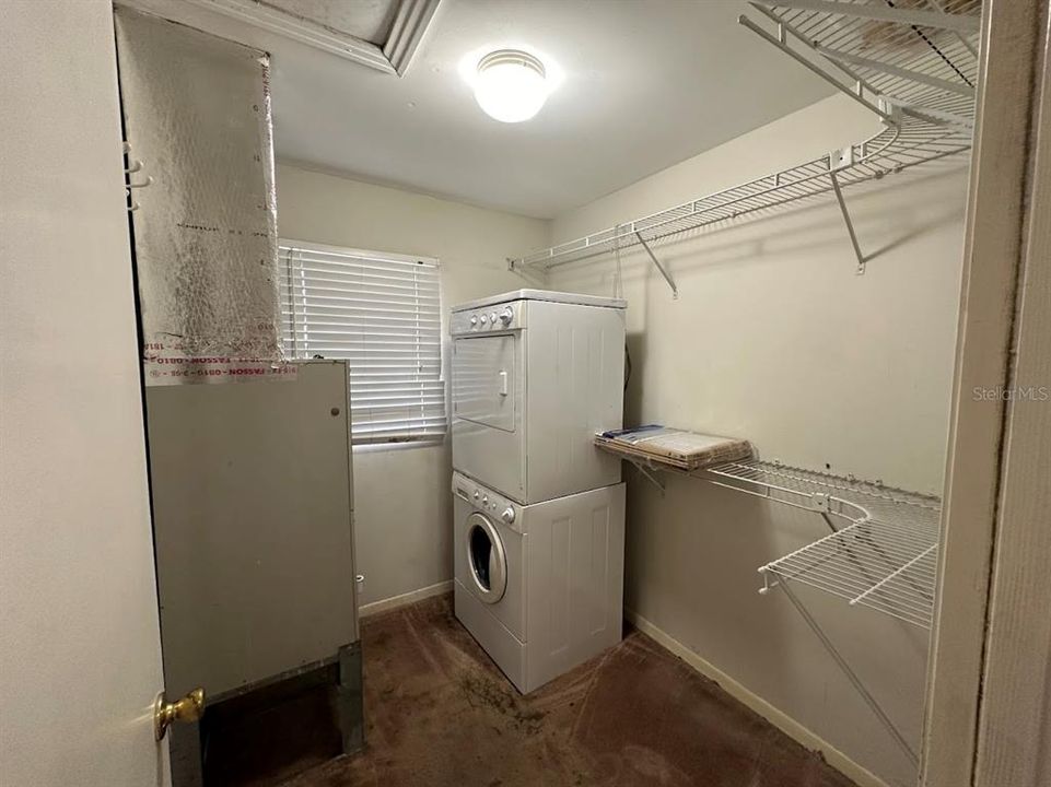 Inside laundry room with storage