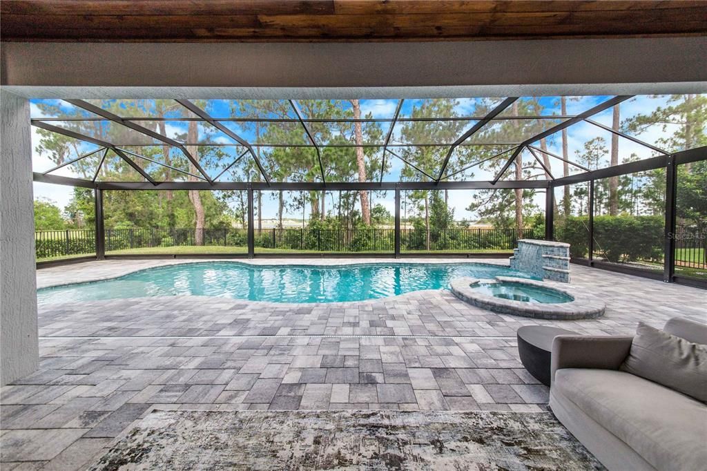 Stunning, Relaxing View of the Salt Water Pool and Beyond is a great place for morning coffee or an evening glass of wine and Sunsets.  Pool is Heated, Has Waterfall, Spillover Spa, Swim up Stools and Sun Shelf