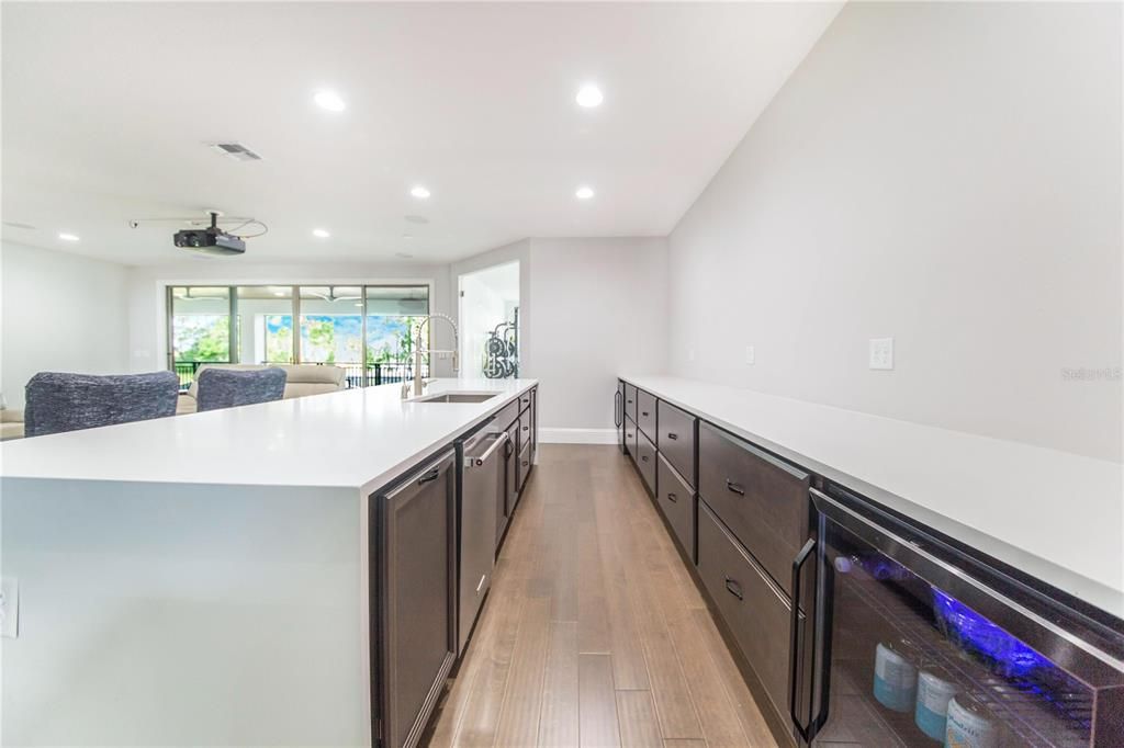 Sports Bar is great for entertaining in the Media Room. View towards the Gym and Sliders to the Screened Rear Balcony