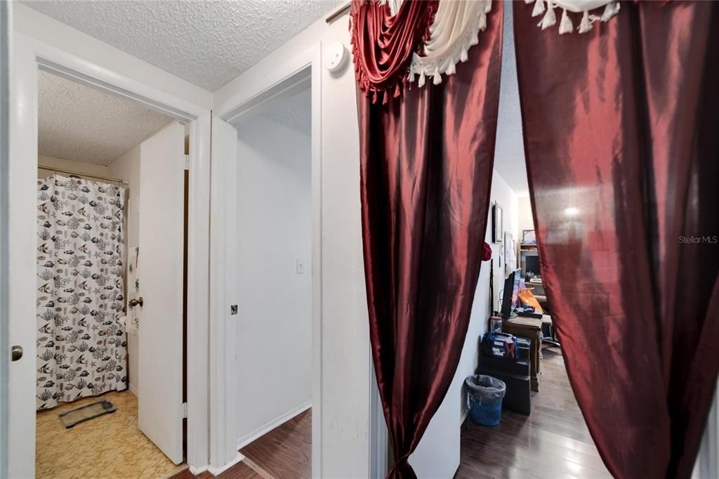 Hallway leading to rooms and bathrooms.