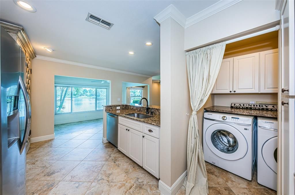 Tucked away from entertainment, the washer and dryer is in its own laundry room.