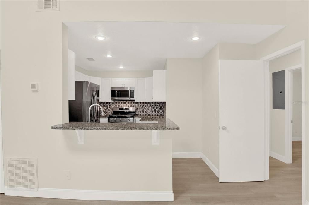 Updated and thoughtfully designed your new kitchen features a modern color palette complementing the SHAKER STYLE CABINETRY, new STAINLESS STEEL APPLIANCES (including a GAS STOVE!) and breakfast bar seating for casual dining or entertaining!