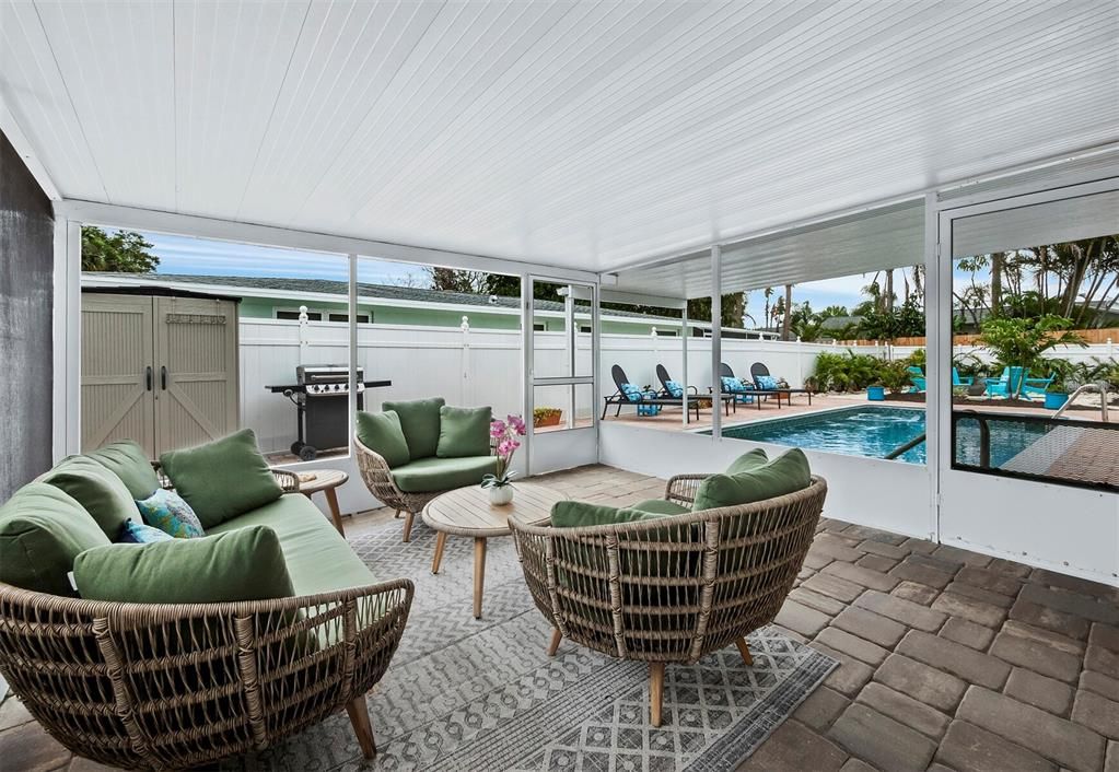 The screened lanai is privately situated and overlooks the pool and sun deck.