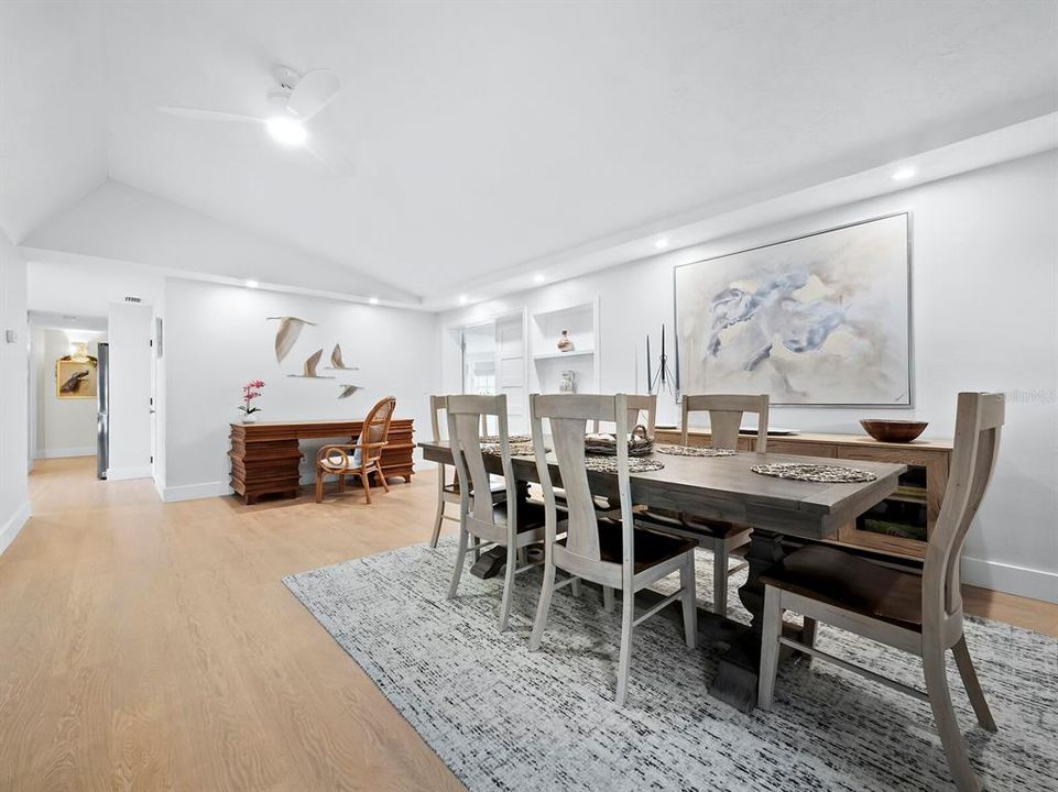 As you enter the home, you'll be greeted by this expansive dining room, illuminated by soft, recessed lights overhead.