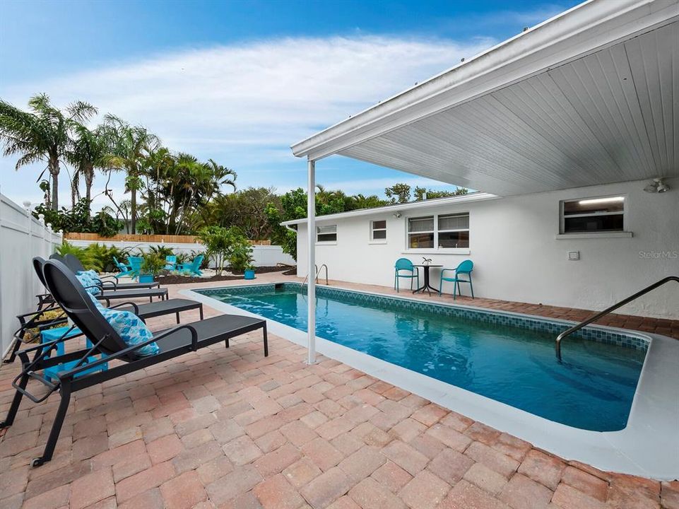 Just outside the screened lanai, enjoy your pool in the sun or shade. This partial shade helps the pool maintain a delightful temperature while also giving you a place to retreat from the sun while still enjoying your time in the pool.