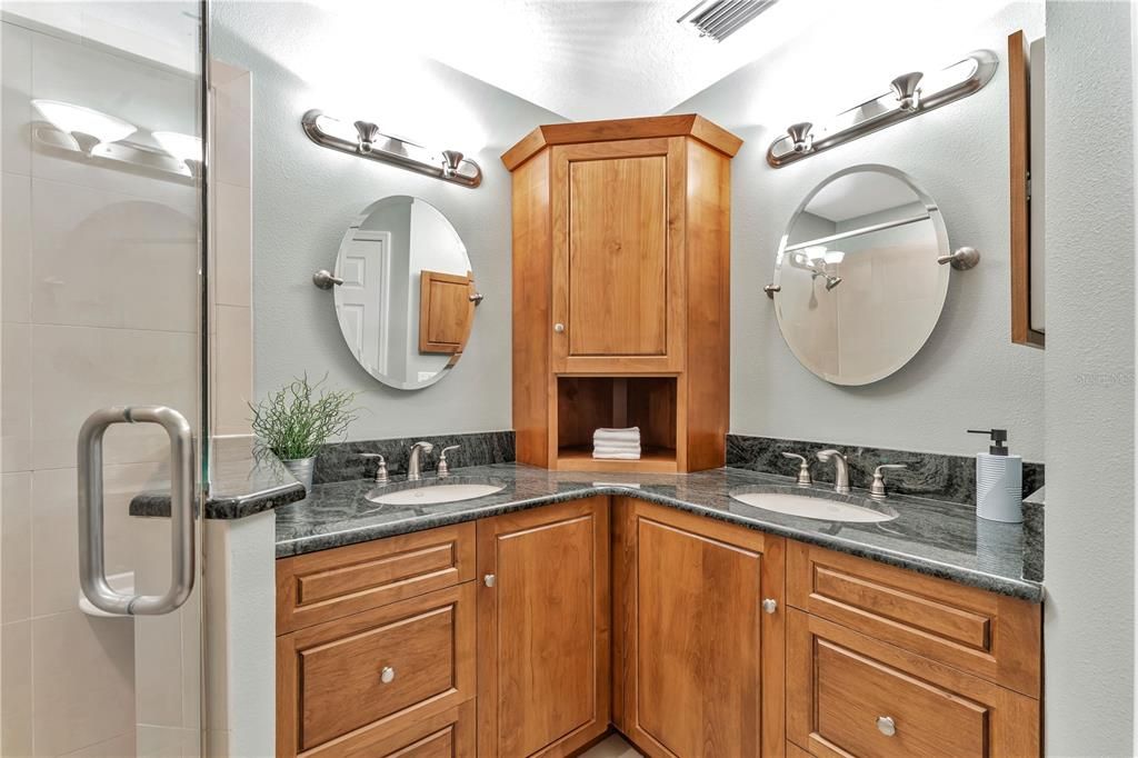 En-Suite Primary Bath Has gorgeous wood Cabinets and Granite tops