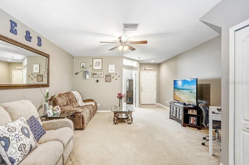 The family room features a ceiling fan, newer paint, a good-sized understairs closet, and a breakfast bar.
