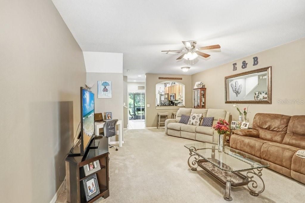 As you enter, you step into the family room which features a lighted ceiling fan, newer paint, a good-sized understairs closet, and a breakfast bar overlooking the kitchen.