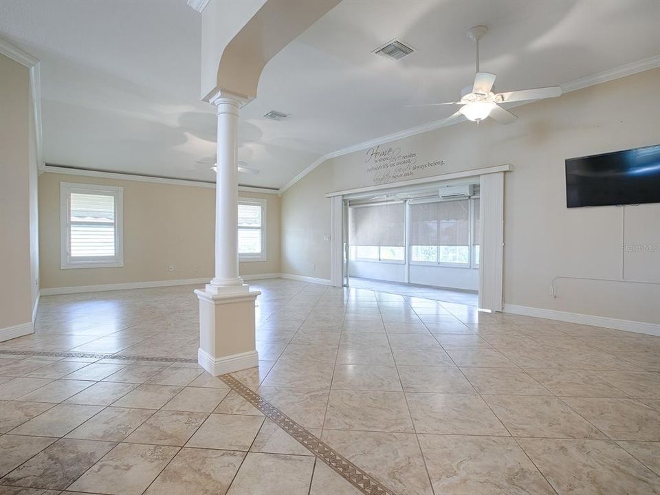 MINI SPLIT UNIT ON LANAI FOR HEAT AND A/C WITH PRIVACY SHADES AND TILE FLOORING.