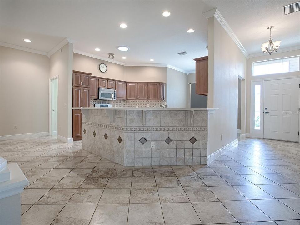 OPEN FLOOR PLAN. LOVELY DIAGONAL TILE THROUGHOUT THIS AREA. THE FORMAL DINING ROOM IS TO THE LEFT WHERE THEY HAVE A "BOAT" BAR.