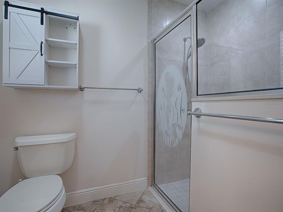 SEPARATE TOILET ROOM WITH SHOWER.