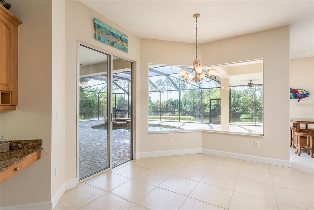 Cascading windows in the kitchen flood the space with natural light, illuminating the room and offering picturesque views of the outdoors, creating a bright and inviting ambiance for culinary adventures.