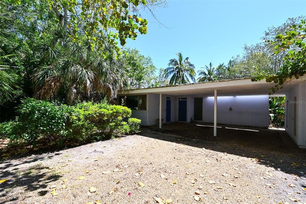 Surrounded by old oak, palm and cedar trees sits this older Mid-Century Modern home in privacy.