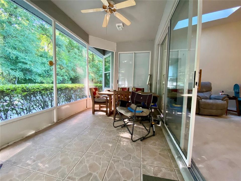 Patio area off of living room with three door slider