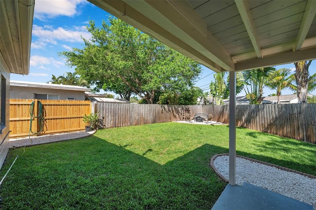 Large backyard with a firepit area and covered walkout