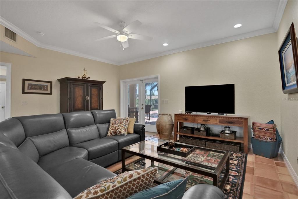 Family room, french doors open to pool and covered lanai.  primary home.