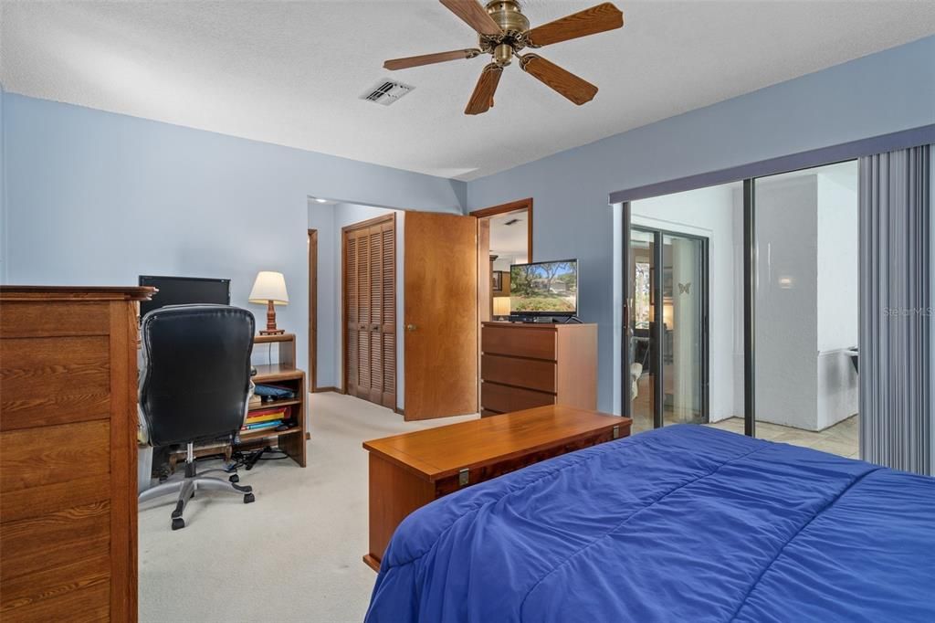 Master Bedroom with sliders to Screened pool area