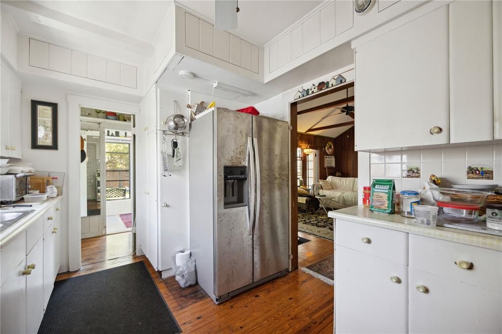 The kitchen has it's own natural lighting and access to the dining room /family room to the right. You also get a ceiling fan as a major bonus to keep the earthy aromas sweeping across the beautiful wooden floors.