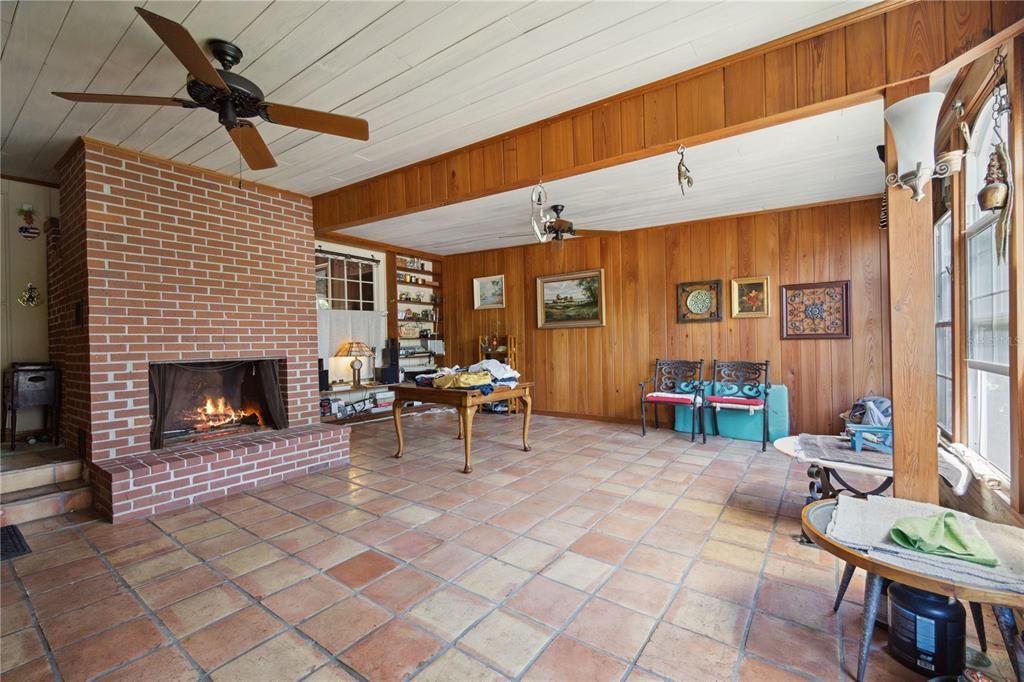 How many Florida homes come with a fireplace these days? I'm unsure, but I know this home does! Check out the Mexican tile flooring throughout this spacious livingroom with the windows facing South. You also get a ceiling fan, and steps leading into he family/ dining room so please be sure to watch your step!