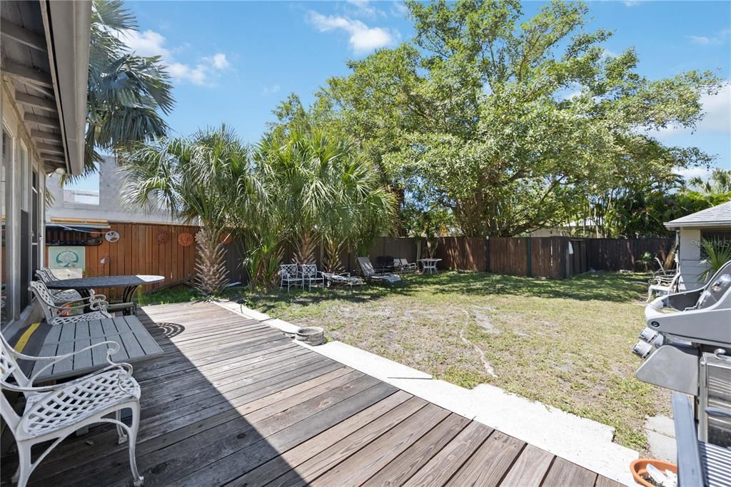 you can enjoy your own backyard since there is a wooden deck already here, or you can add a pool! The fence line in this photo is on the west side of the property.