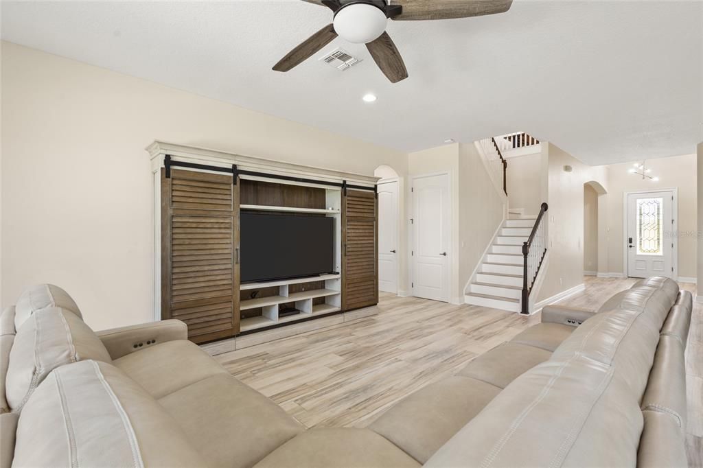 Family room with ceiling fan and triple sliding glass doors to the pool area!