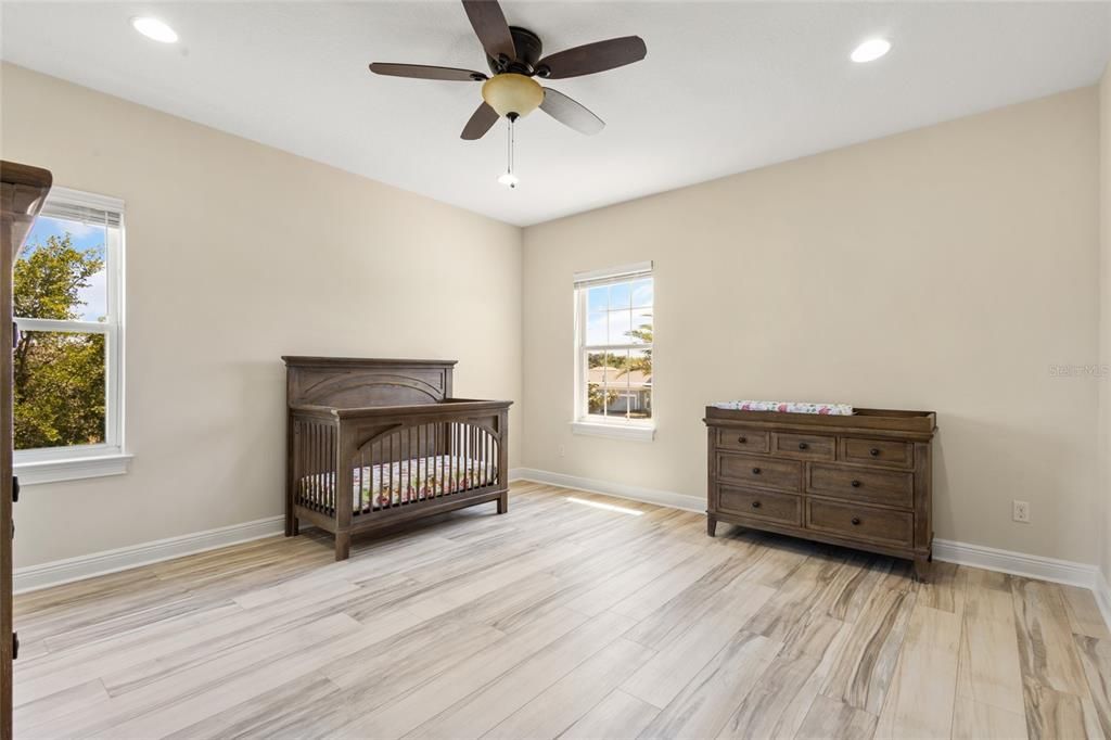 Bedroom 5 offers a walk in closet, ceiling fan and new laminate flooring!