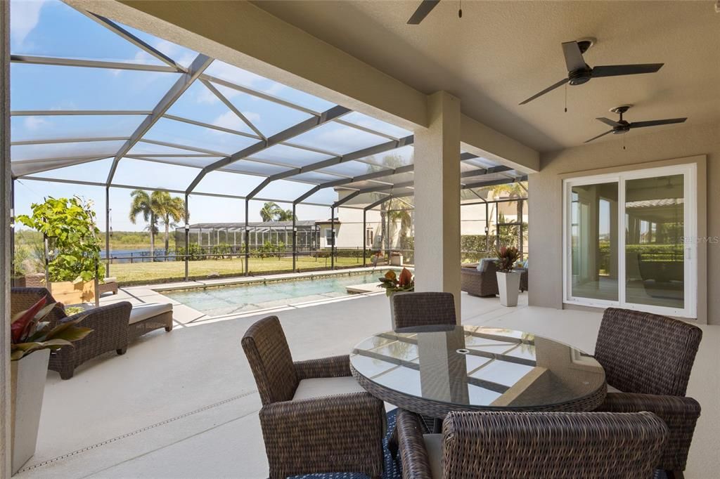 Plenty of space here to dine under the expansive covered patio and screened lanai covering the pool area!