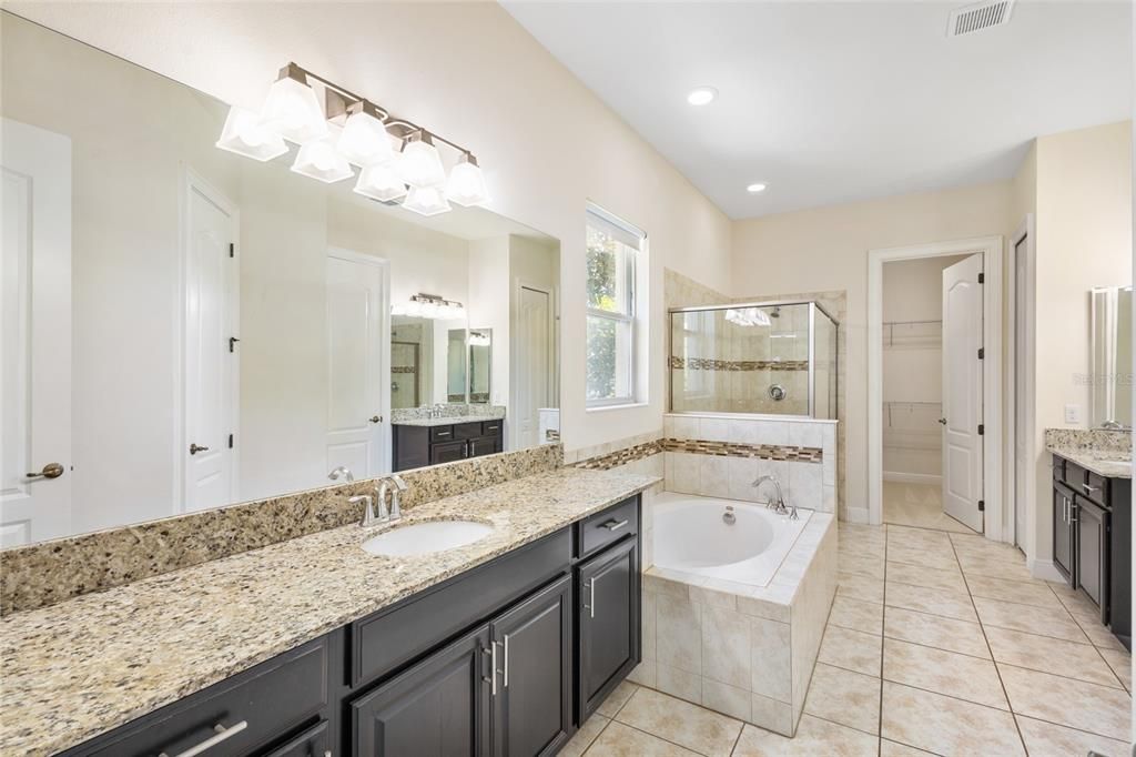 HUGE master bath 18x14 with 2 espresso vanities with granite counters, soaking tub, full shower and 2 walk in closets.