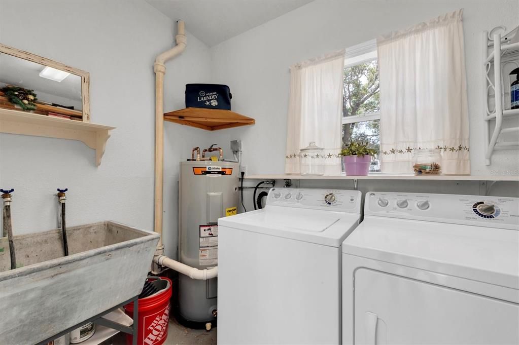 Laundry with an old school tub sink for extra washing. And, a brand new Water Heater!