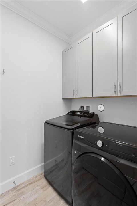 Laundry room with storage cabinets.